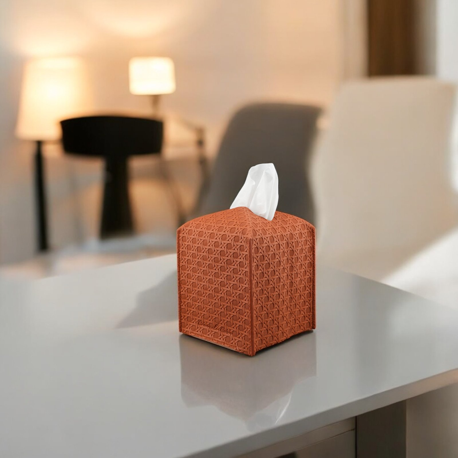 Camel rattan-style vegan leather tissue box cover on a bedside table with a lamp