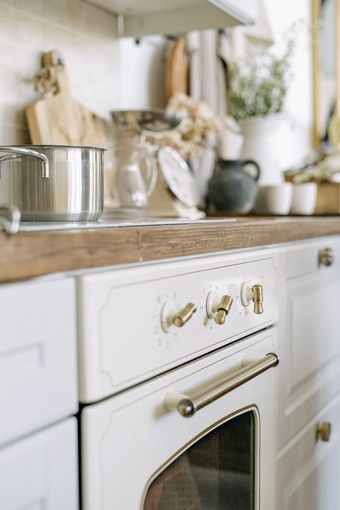 A cozy rustic kitchen featuring a vintage white oven and wooden countertop. Perfect for home interior inspiration.